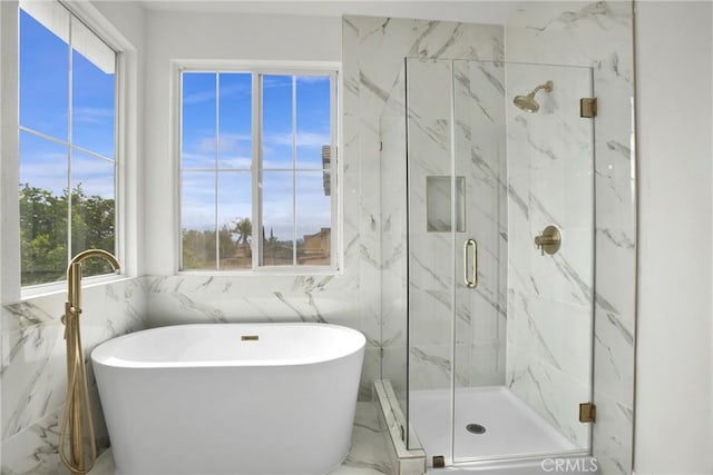 full bath featuring a marble finish shower, a freestanding bath, and marble finish floor