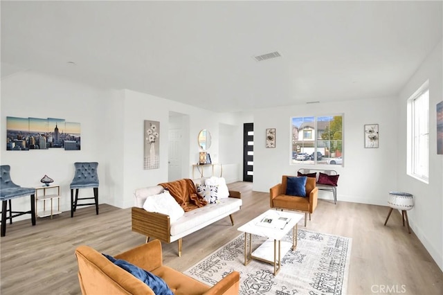 living room with visible vents and wood finished floors