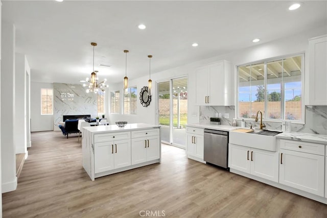 kitchen featuring white cabinetry, light wood-style flooring, recessed lighting, decorative backsplash, and stainless steel dishwasher