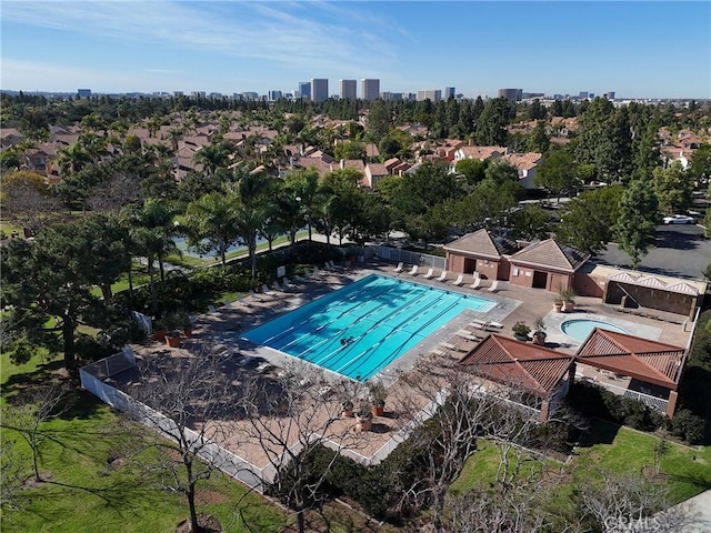 community pool with fence and a patio area