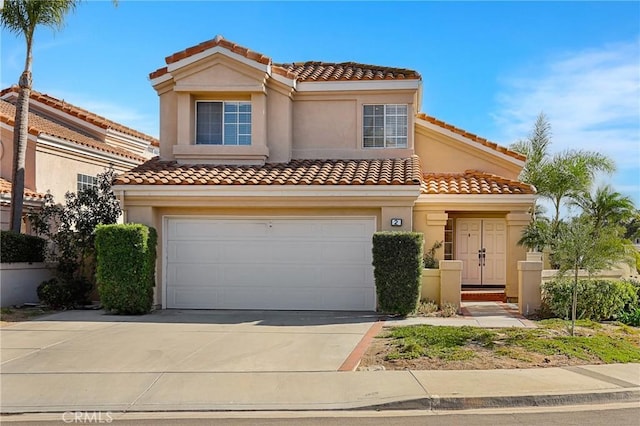 mediterranean / spanish house with concrete driveway, a garage, and stucco siding