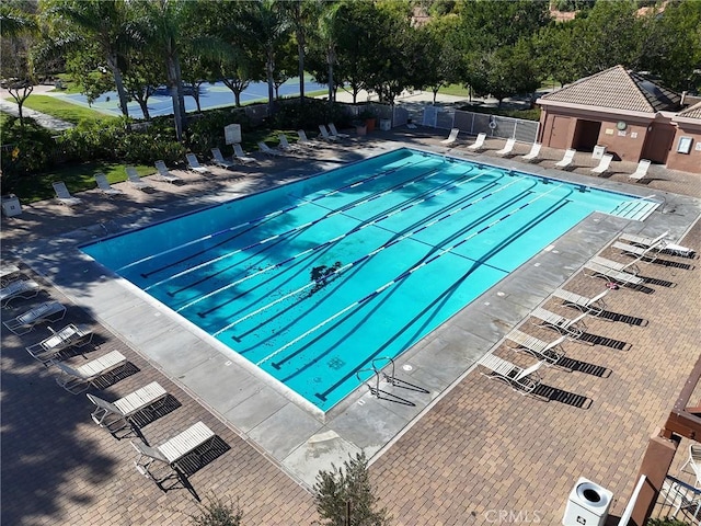 pool with fence and a patio area