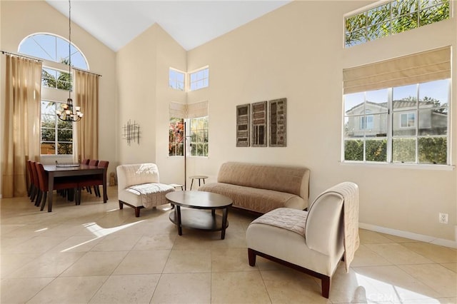 interior space featuring tile patterned floors, a notable chandelier, plenty of natural light, and high vaulted ceiling