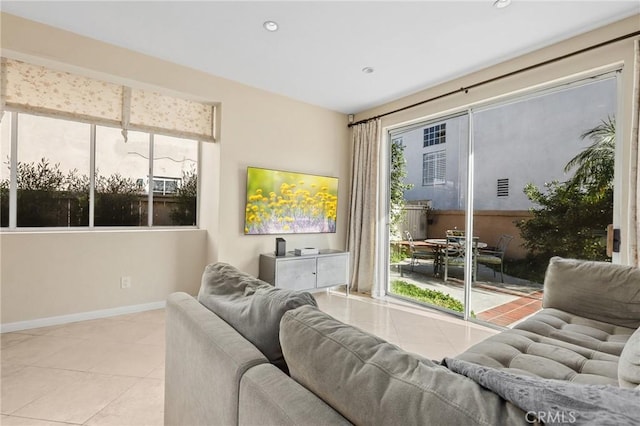 living area featuring tile patterned flooring, recessed lighting, and baseboards