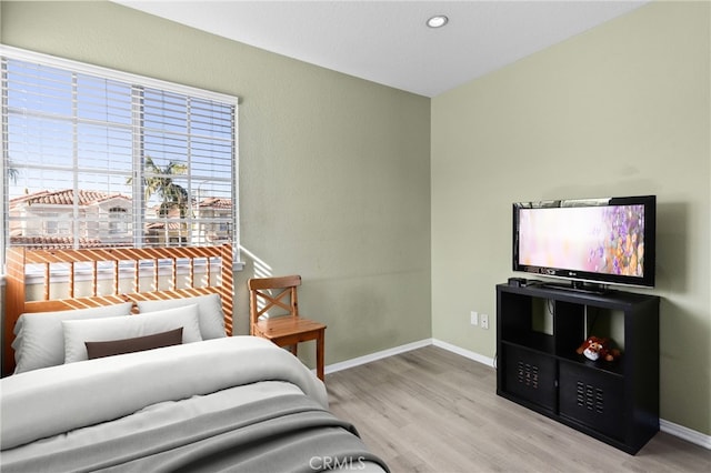 bedroom with recessed lighting, baseboards, and wood finished floors