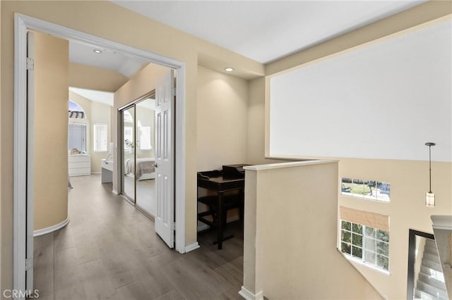 hall with an upstairs landing, recessed lighting, baseboards, and wood finished floors