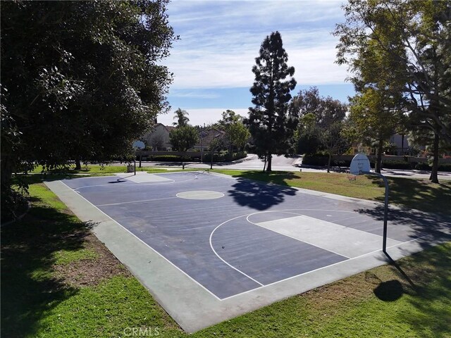 view of basketball court with community basketball court and a yard