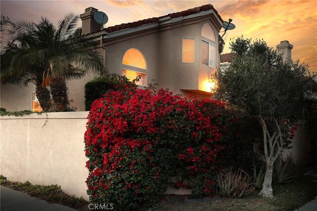 property exterior at dusk with stucco siding