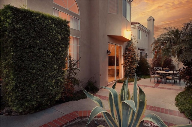 patio terrace at dusk featuring outdoor dining space