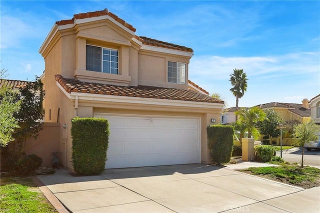 view of front facade with stucco siding, driveway, a tile roof, and a garage