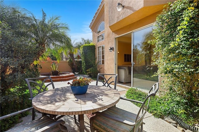 view of patio / terrace with outdoor dining space and fence