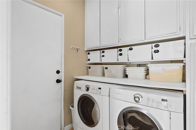 washroom featuring washing machine and clothes dryer and cabinet space