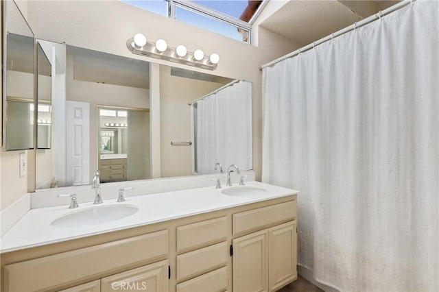 full bath featuring double vanity and a sink