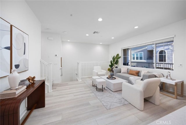 living room featuring visible vents, recessed lighting, and light wood-type flooring