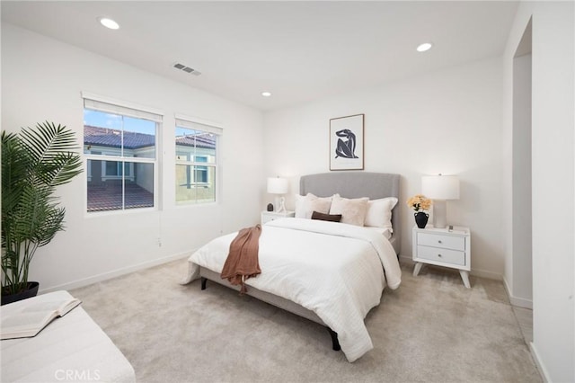 bedroom with recessed lighting, visible vents, light carpet, and baseboards