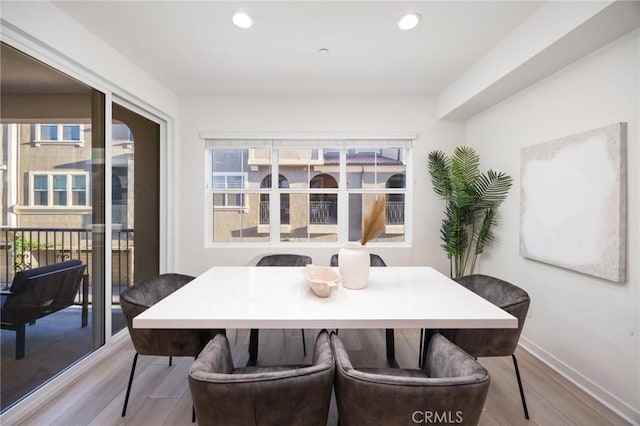 dining room featuring recessed lighting, baseboards, and wood finished floors