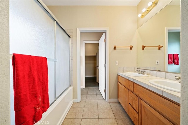 full bathroom with tile patterned floors, enclosed tub / shower combo, double vanity, and a sink