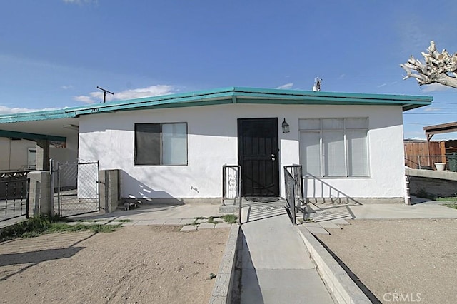 1111 Taos Dr, Barstow, CA 92311 - view of front of property with a gate and stucco siding