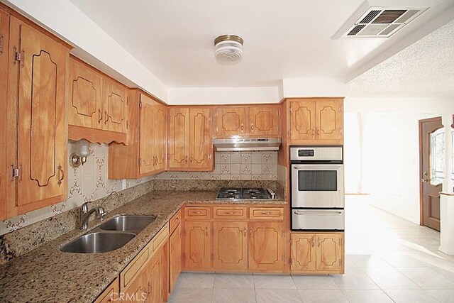 1111 Taos Dr, Barstow, CA 92311 - kitchen with a warming drawer, appliances with stainless steel finishes, a sink, extractor fan, and light tile patterned floors