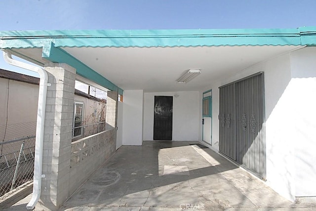 1111 Taos Dr, Barstow, CA 92311 - property entrance with stucco siding and an attached carport