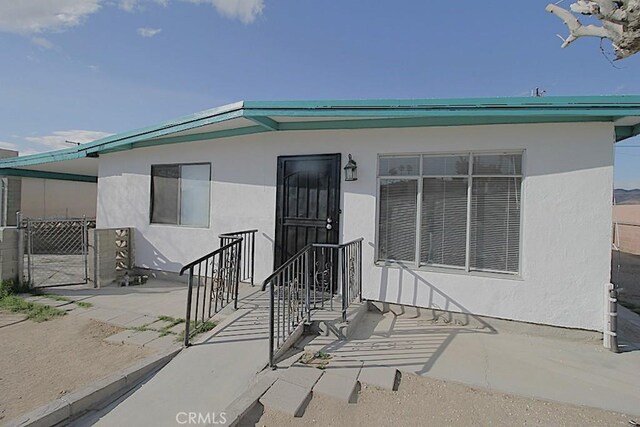 1111 Taos Dr, Barstow, CA 92311 - property entrance featuring stucco siding
