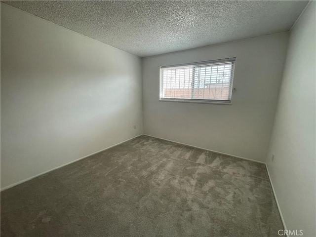 1111 Taos Dr, Barstow, CA 92311 - carpeted spare room with a textured ceiling and baseboards