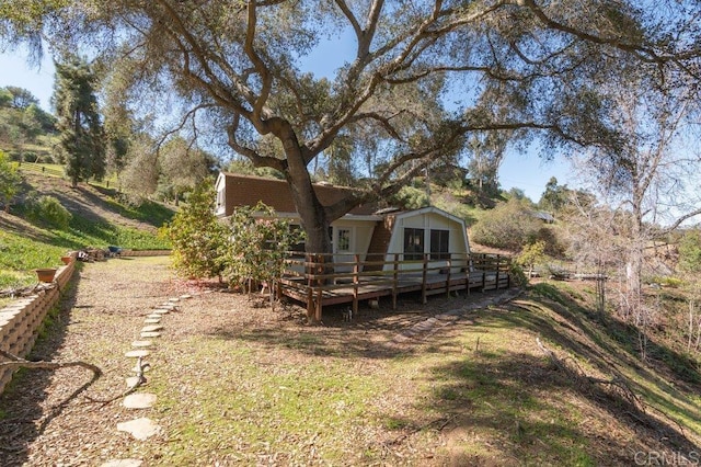 view of yard with a wooden deck