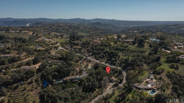 aerial view featuring a forest view and a mountain view