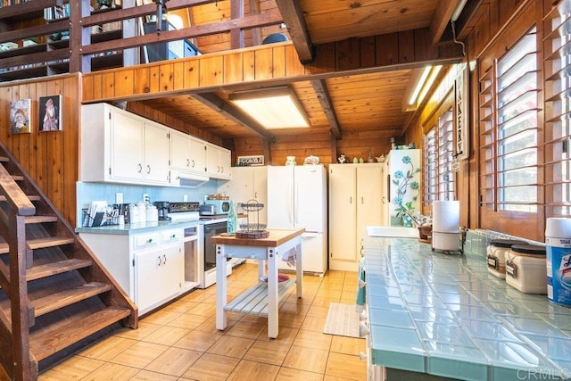 kitchen featuring white cabinetry, white appliances, tile countertops, and a sink