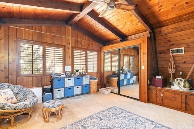 living area with lofted ceiling with beams, wood ceiling, and wood walls