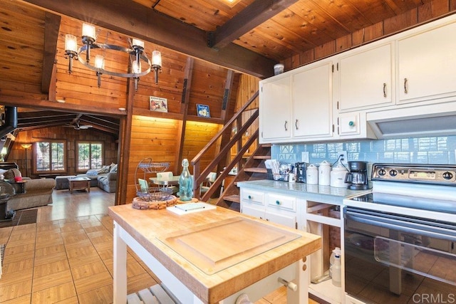 kitchen with vaulted ceiling with beams, butcher block countertops, stainless steel electric stove, wood ceiling, and white cabinetry