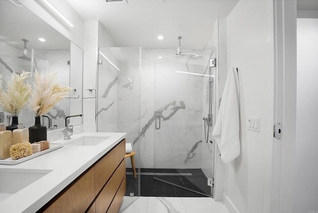 full bathroom featuring marble finish floor, recessed lighting, a sink, and a marble finish shower