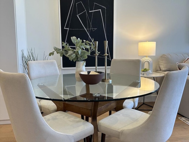 dining space with wood finished floors