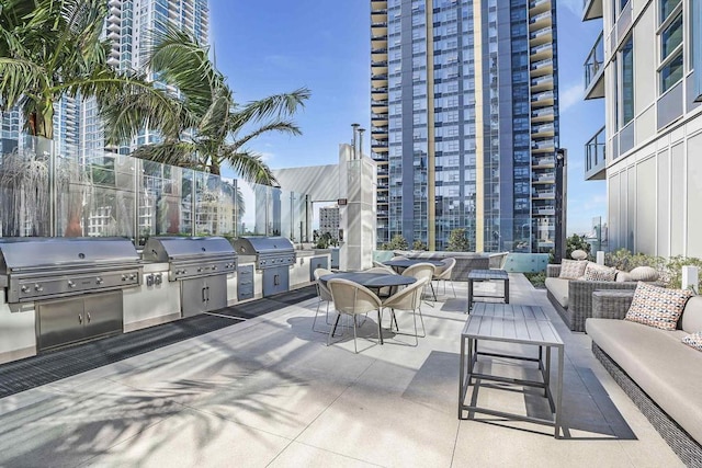 view of patio with a grill, exterior kitchen, and outdoor lounge area