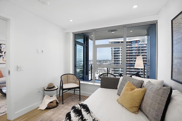 bedroom with baseboards and wood finished floors