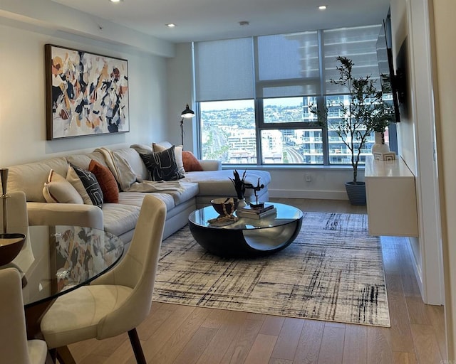 living area featuring hardwood / wood-style flooring and recessed lighting