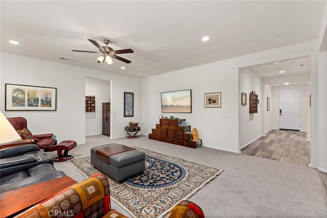 living room featuring recessed lighting, visible vents, baseboards, and carpet flooring