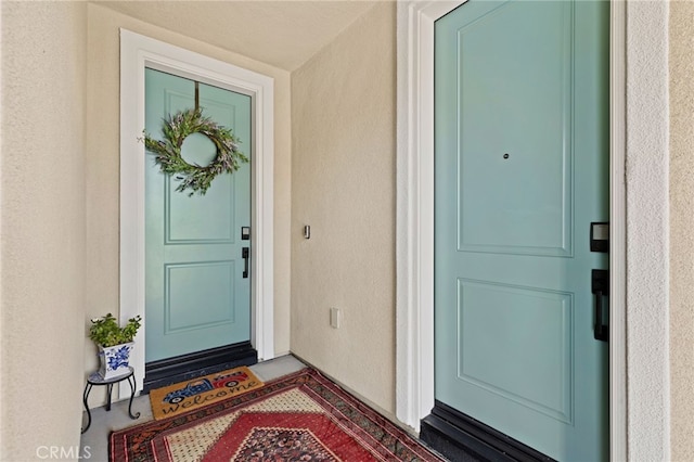 view of exterior entry featuring stucco siding