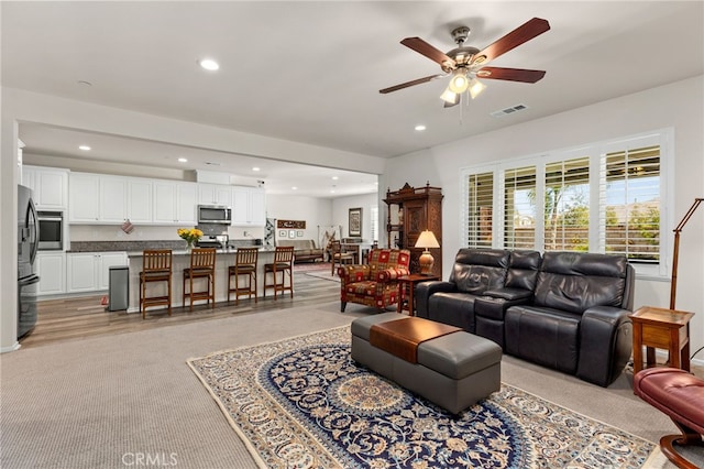 living area featuring recessed lighting, visible vents, and ceiling fan