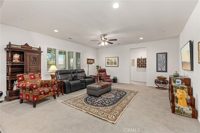 carpeted living area featuring recessed lighting, visible vents, baseboards, and ceiling fan