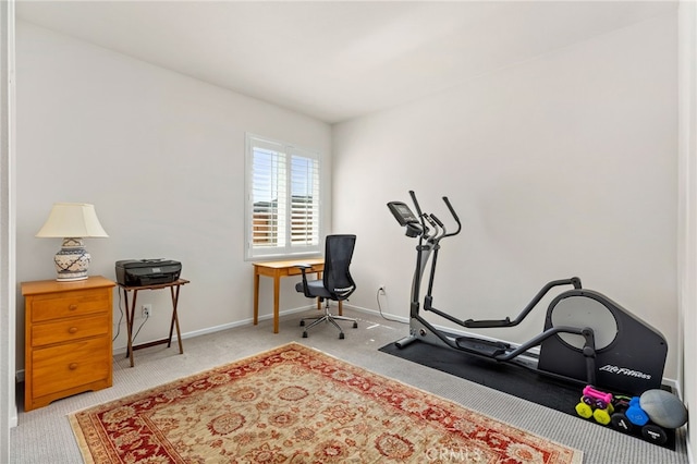 workout room featuring carpet flooring and baseboards