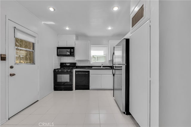 kitchen featuring a sink, decorative backsplash, black appliances, white cabinets, and dark countertops