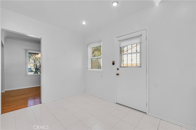 foyer with recessed lighting and baseboards