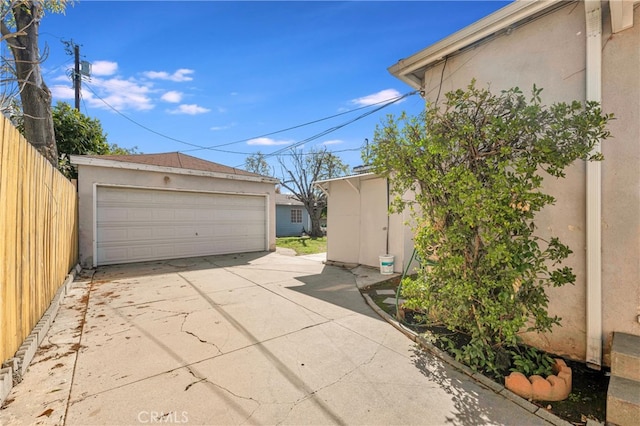 detached garage featuring fence