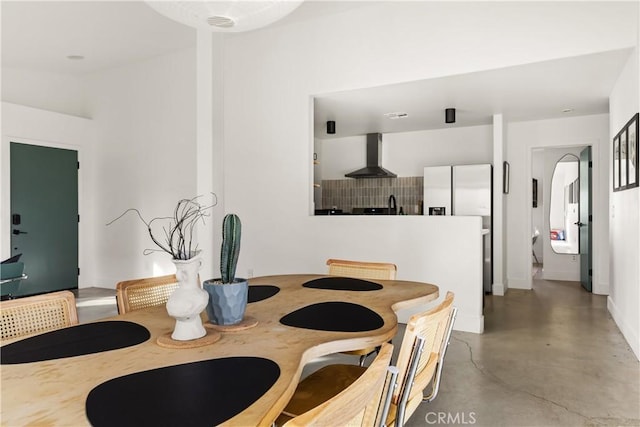 dining space featuring finished concrete floors