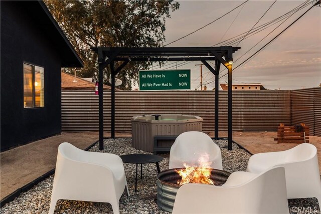 view of patio featuring an outdoor fire pit and fence