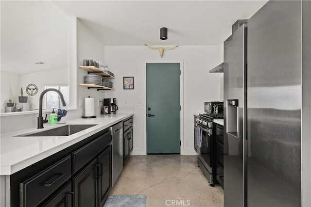 kitchen featuring finished concrete flooring, open shelves, a sink, light countertops, and appliances with stainless steel finishes