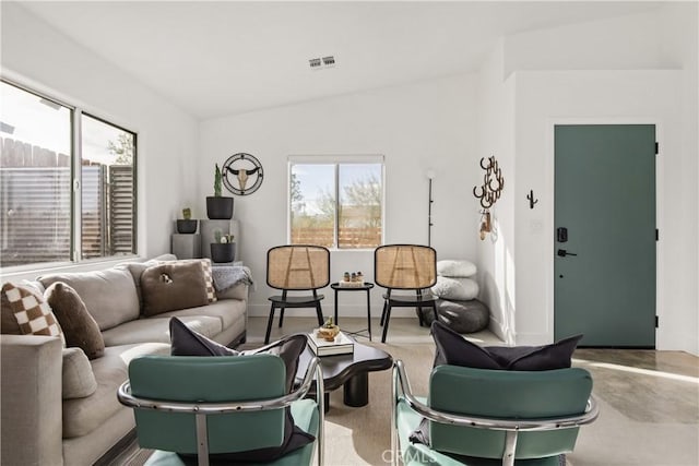 living room with visible vents, baseboards, and vaulted ceiling