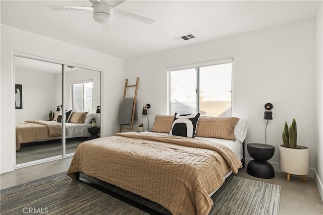 bedroom featuring multiple windows, visible vents, a closet, and ceiling fan