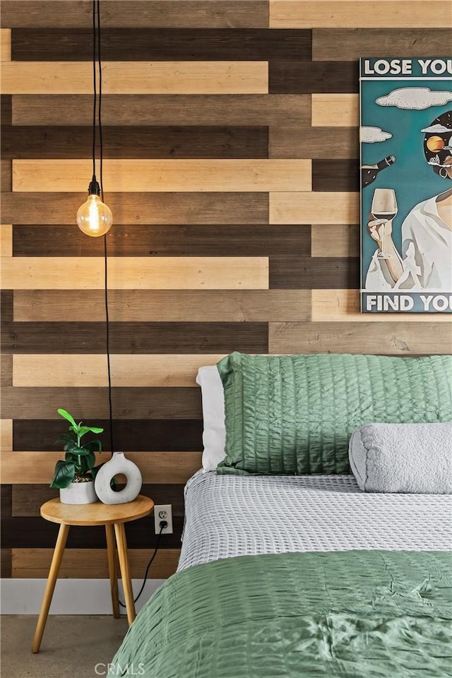 bedroom featuring wooden walls